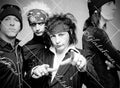 L.A. Guns up close pointing to lens