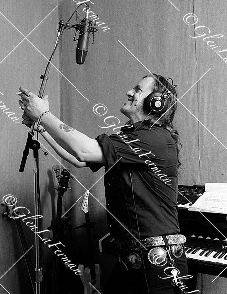 Lemmy Kilmister in studio with mic, reaching out