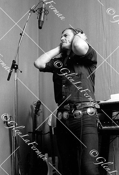 Lemmy Kilmister in studio with mic, holding headphones