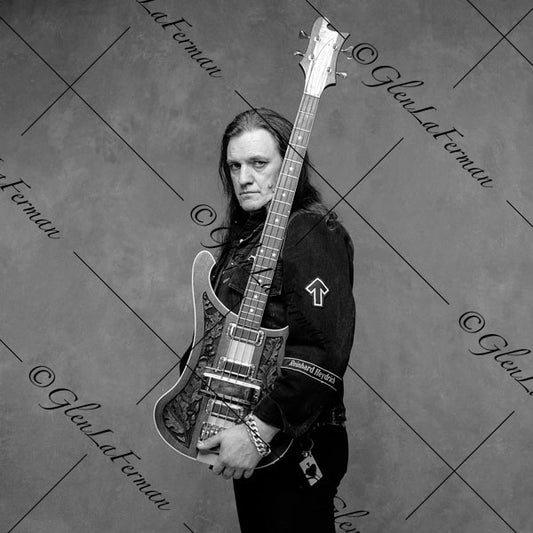 Lemmy Kilmister holding guitar close