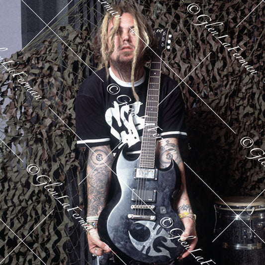 Max Cavalera standing with black guitar