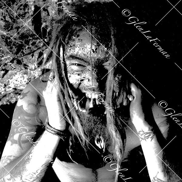 Max Cavalera in cave biting down