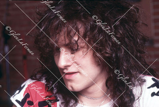 Vivian Campbell close up in studio, looking down