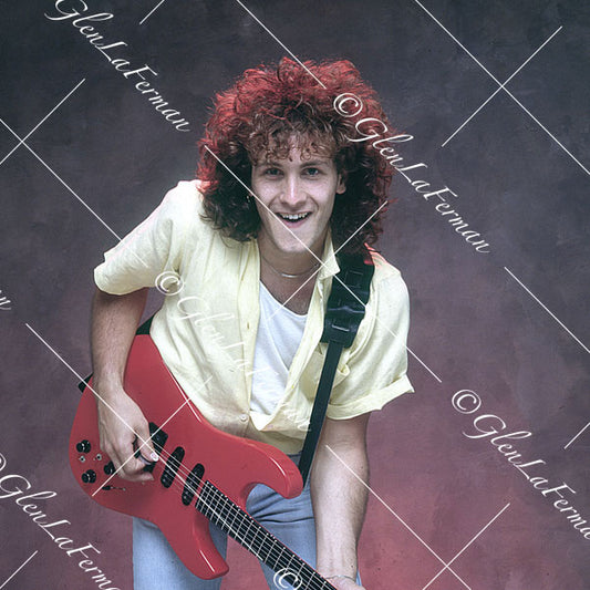 Vivian Campbell in jeans with red Fender