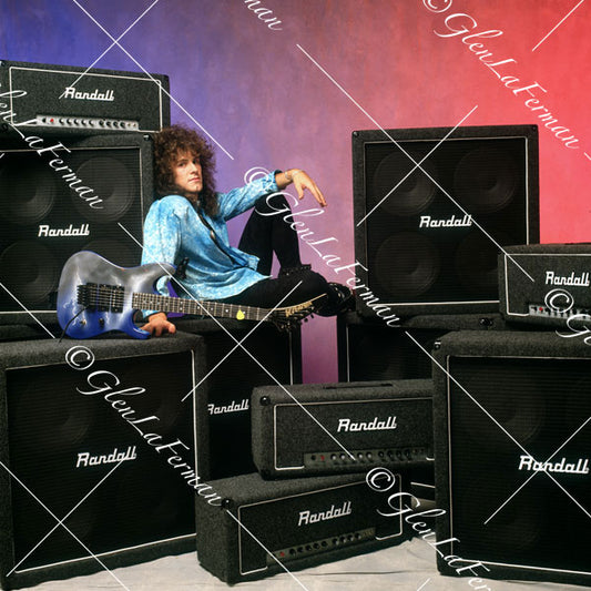 Vivian Campbell in studio leaning back on amps