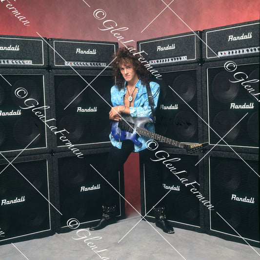 Vivian Campbell in wide stance in front of amps