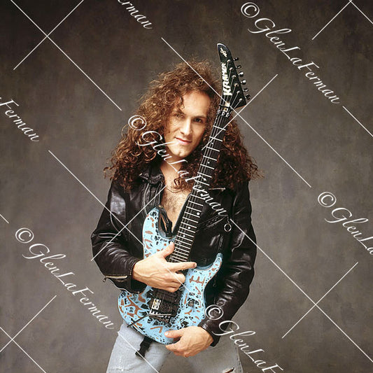 Vivian Campbell in jeans holding blue Kramer Frankenstrat